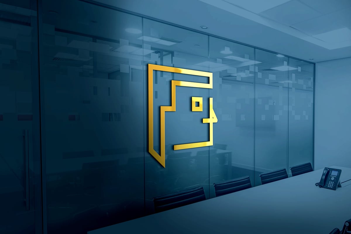 Golden sculpted brand logo displayed on an office meeting-room wall