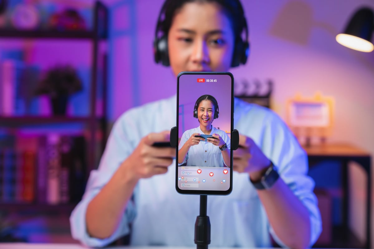 Content creator filming short-form video for social media with a smartphone and ring light
