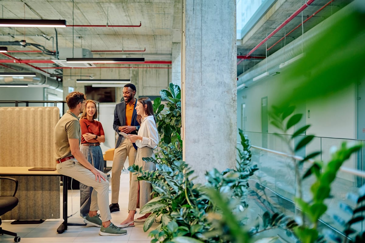 Diverse business team collaborating on a digital marketing project in a modern office
