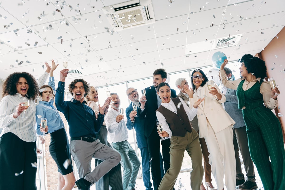 Celebratory team gathering at a modern creative studio
