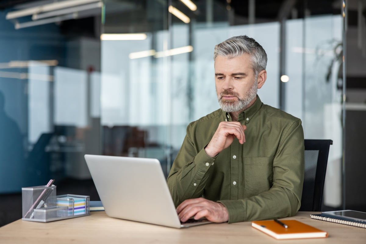 Business owner reviewing marketing strategy and planning next steps on a laptop
