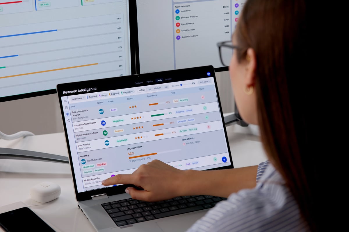Business owner reviewing sales lead data and pipeline performance on a laptop