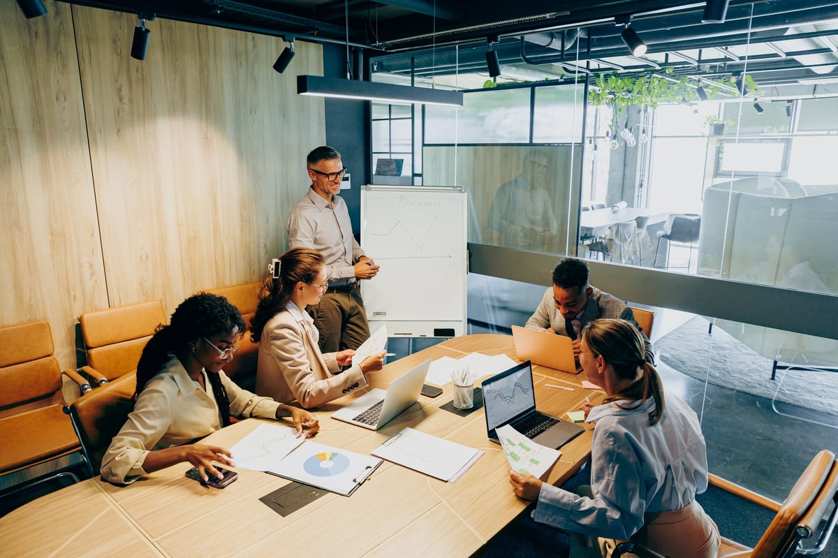 Creative agency team planning a project around a modern boardroom table