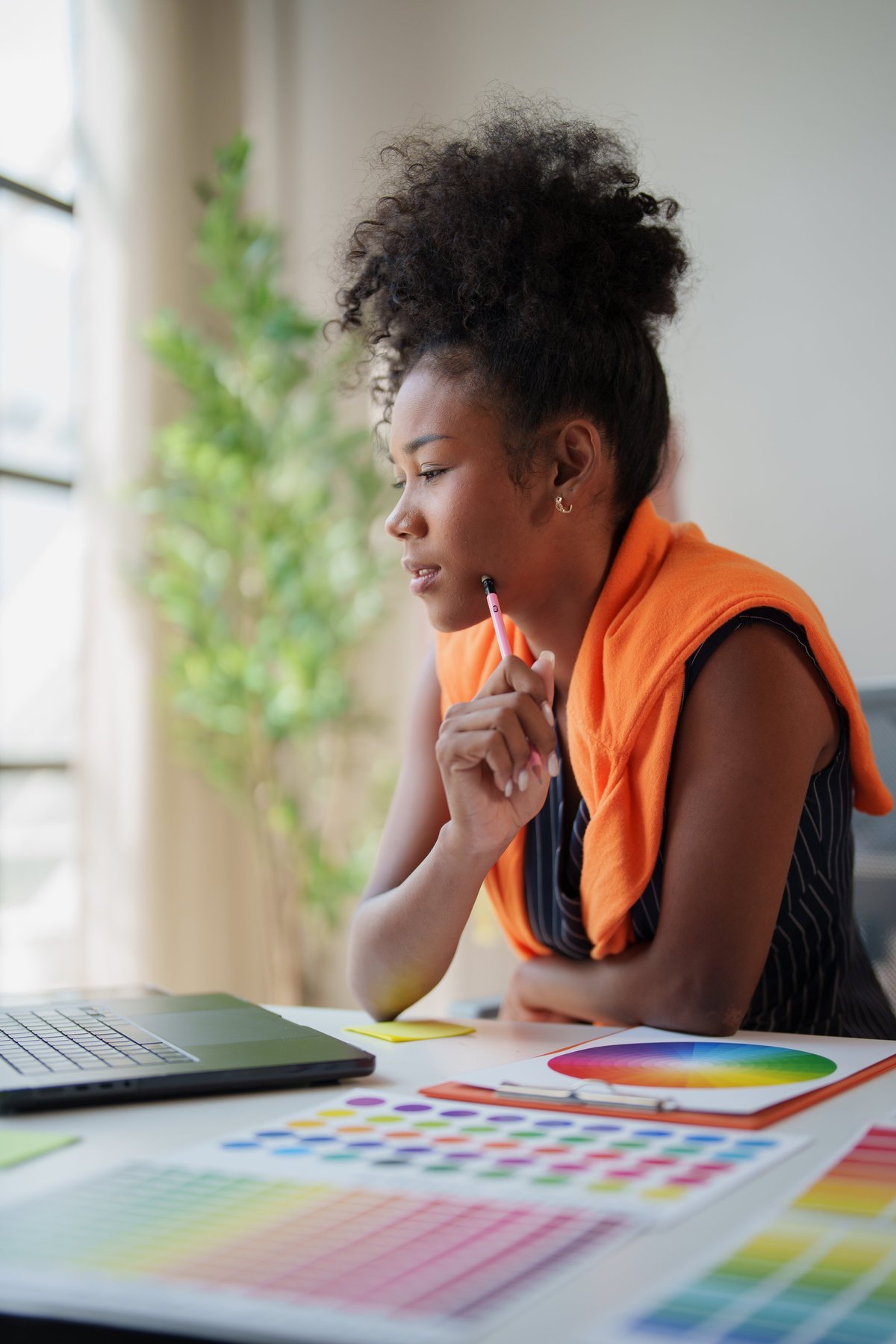 Graphic designer exploring colour options and creative ideas while designing a brand identity